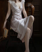 Darette Long Story Slip in Mauve - seated pose with the satin skirt flowing, showing the long slim silhouette