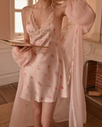 Darette Loose Ends Slip in Blush - front view standing with a matching robe, holding a book