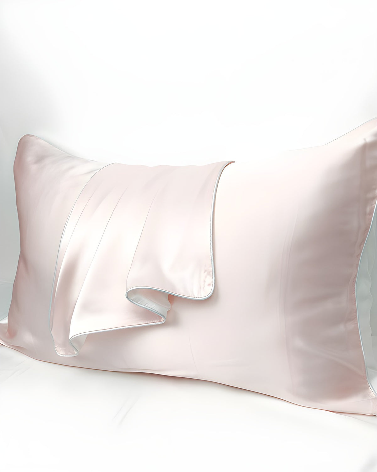 Close-up of the Darette Night Shift Silk Pillowcase in Blush, showing the satin sheen and folded corner