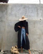 Darette Out of Office Cover-Up in Noir - robe worn open over jeans, styled with a straw hat and tote
