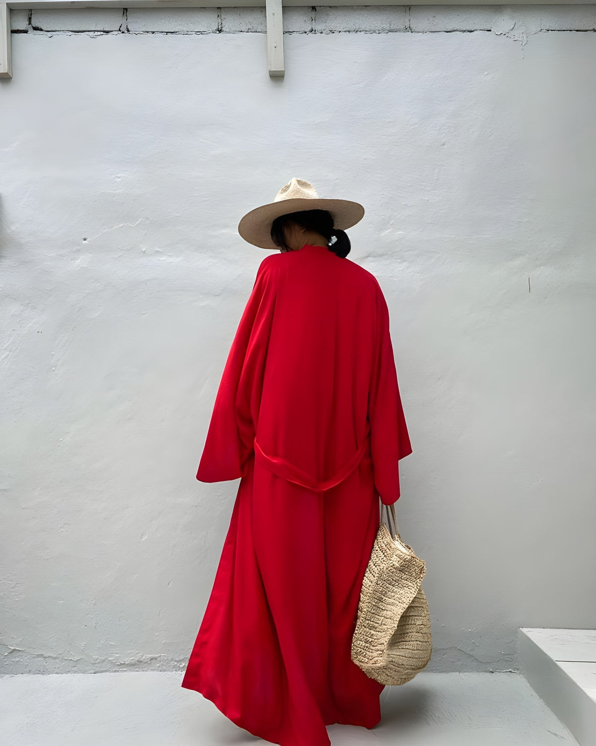 Back view of the Darette Out of Office Cover-Up in Red - kimono-style robe styled with a wide-brim hat