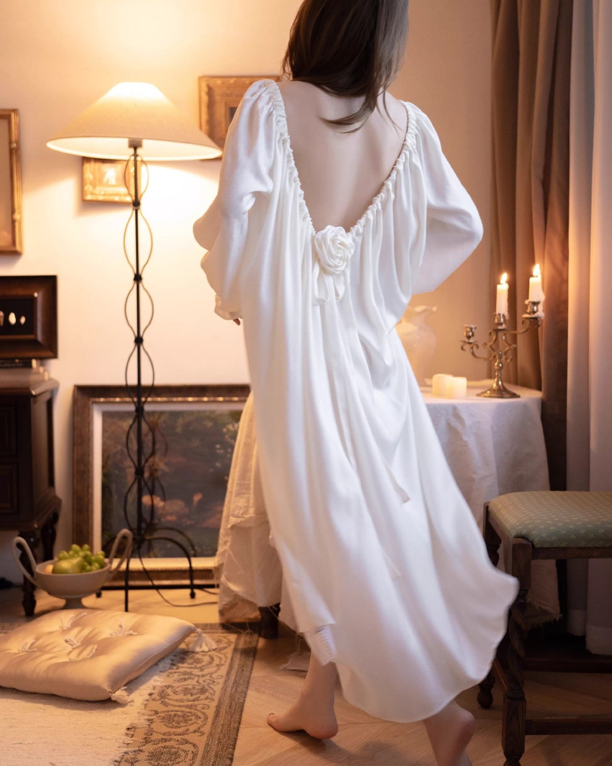 Back view of the Darette Rose to the Occasion Gown in motion, showing the open back and rose tie