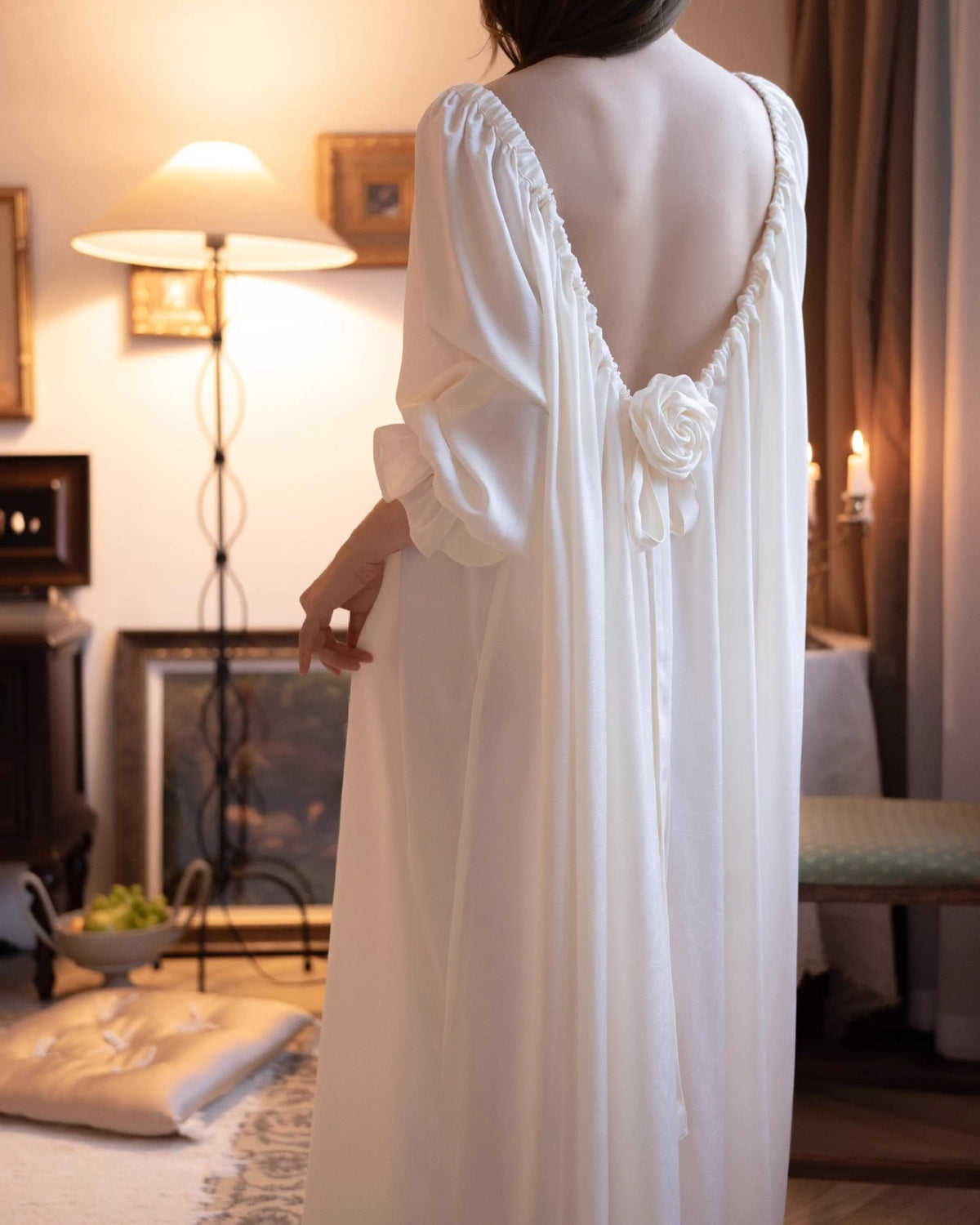 Back view of the Darette Rose to the Occasion Gown walking through a candlelit room
