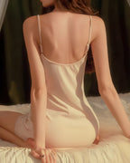 Back view of the Darette Second Nature Slip in Creme, kneeling on a bed