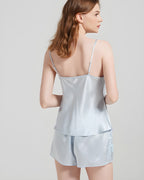 Darette Short Notice Silk Set in Sky - back view standing near a window in the silk cami and shorts set