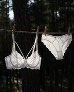 Darette Small Dare Sheer Set in Ivory hanging outdoors on a clothesline, showing sheer lace