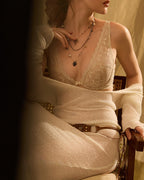 Darette Soft Landing Lace Set in Champagne - front view of the lace bra and brief with a cream cardigan draped over the shoulders