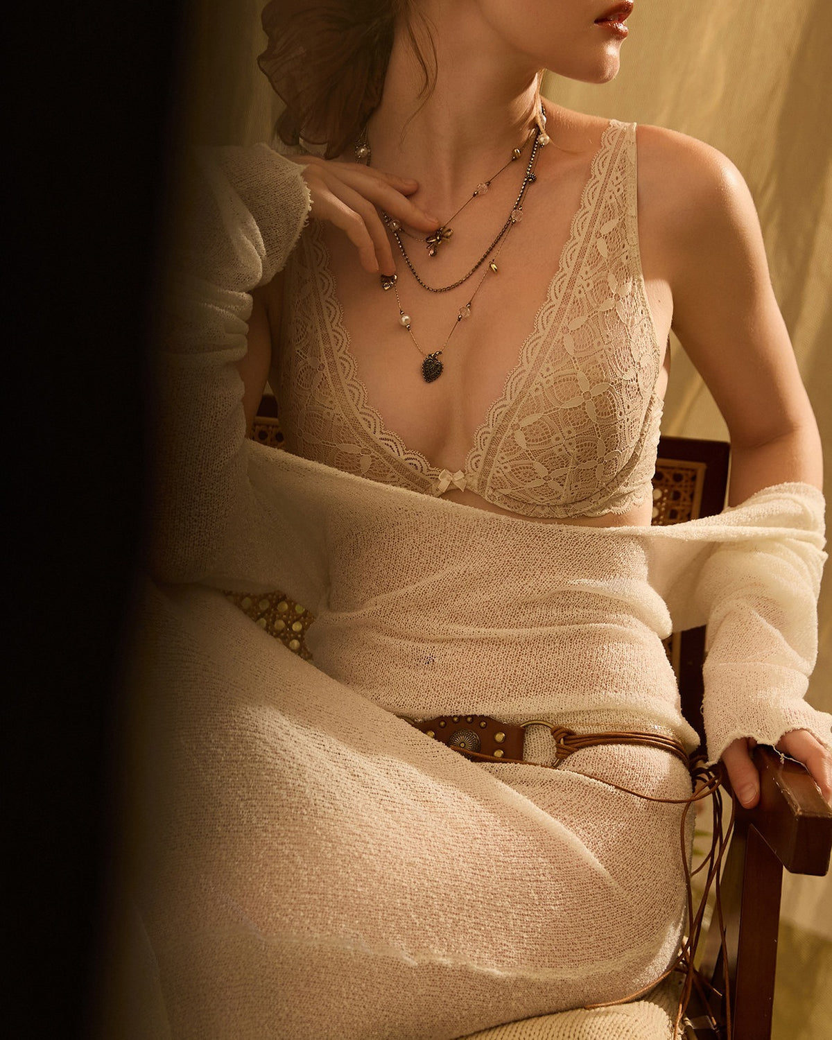 Darette Soft Landing Lace Set in Champagne - front view of the lace bra and brief with a cream cardigan draped over the shoulders