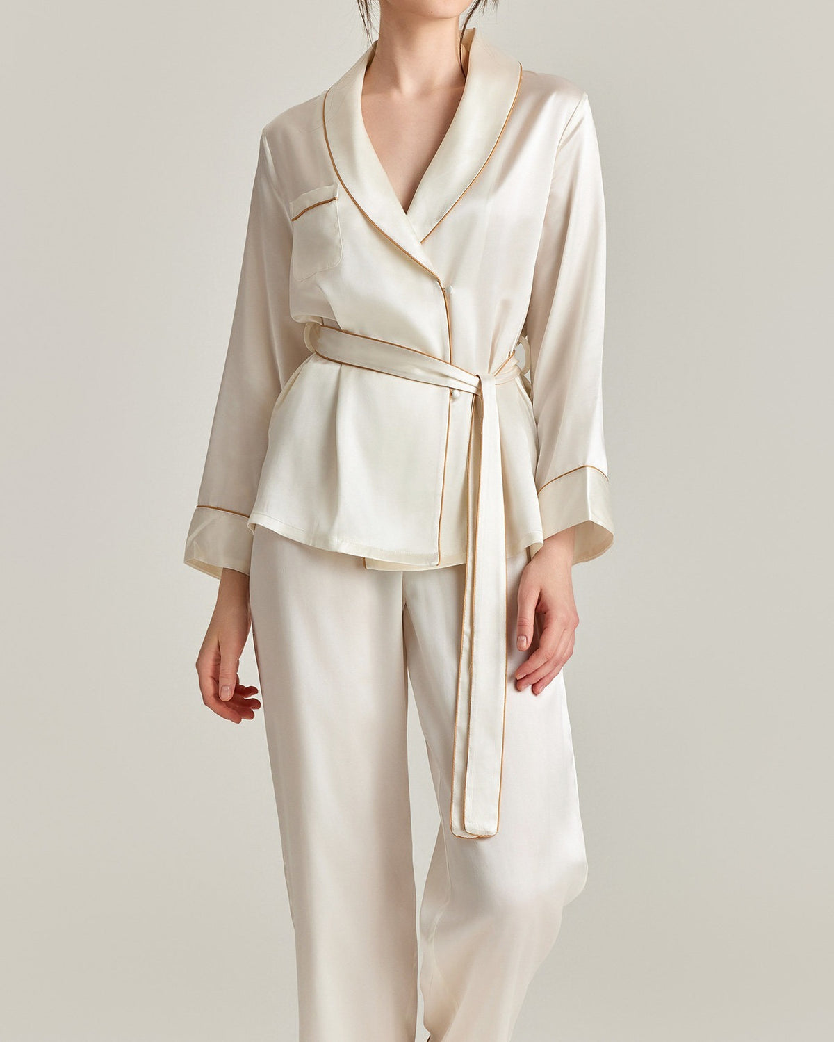Darette The Long Weekend Silk Set in Ivory - shawl-collar wrap shirt with contrast piping and tie belt, studio front view