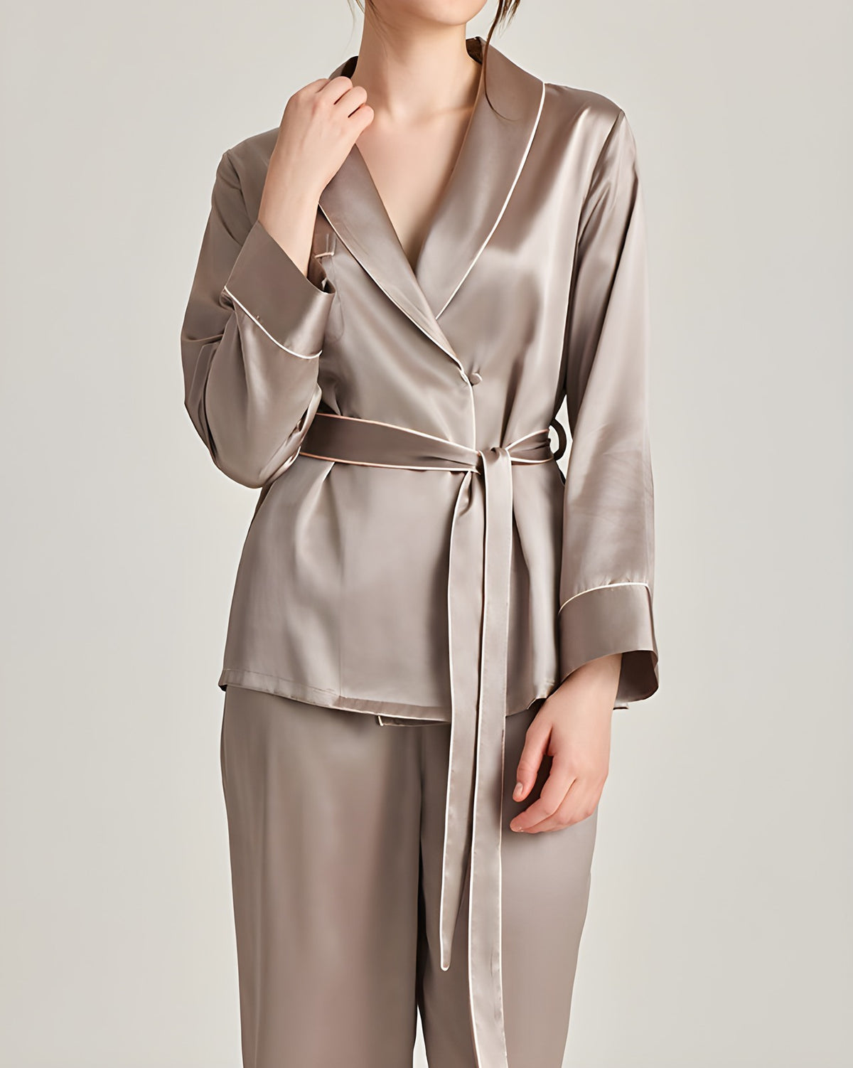Darette The Long Weekend Silk Set in Mist - wrap shirt with piped shawl collar, hand at the collar, studio view