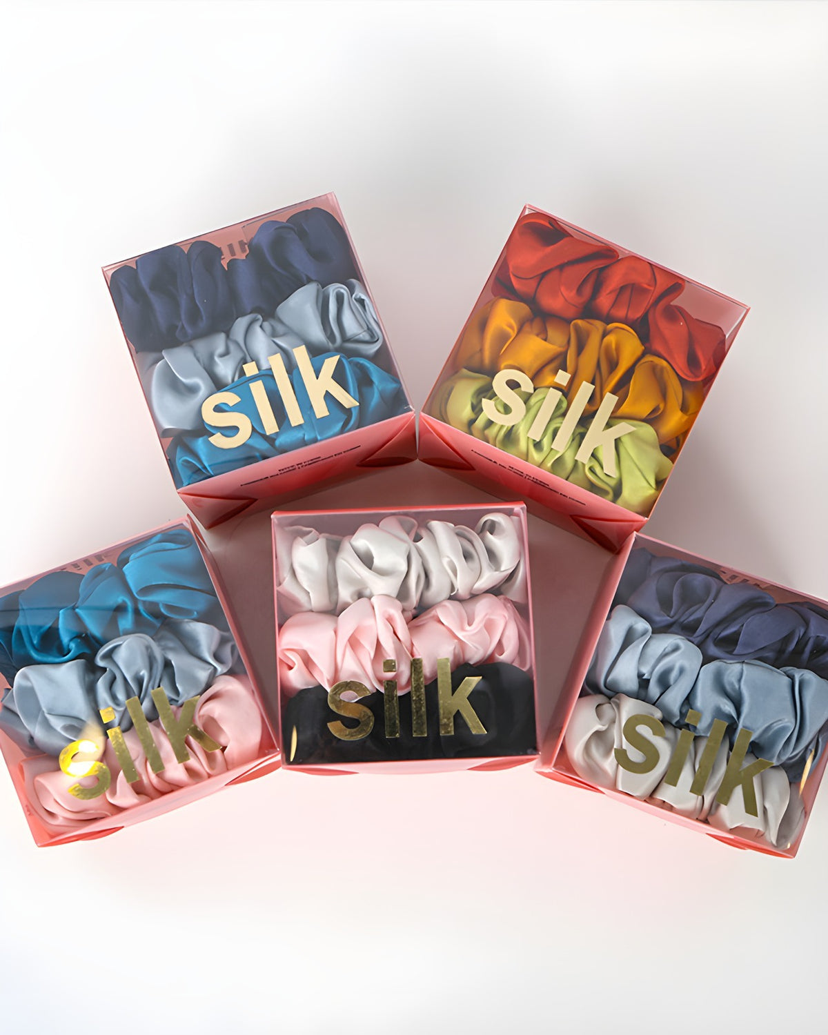 Darette The Understudy Scrunchie Set - five silk scrunchie gift boxes arranged together showing the colour range