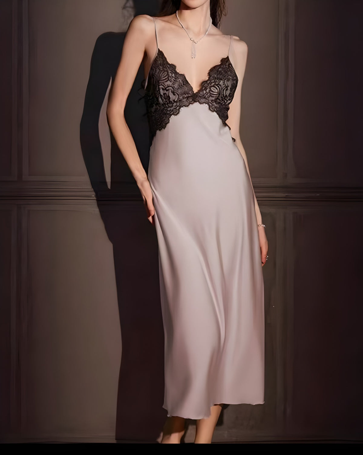 Darette Trailing Off Slip in Blush - lace-bodice satin slip dress standing against a plain wall