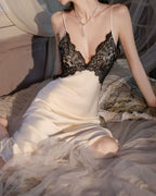 Darette Trailing Off Slip in Champagne - lace-bodice slip dress seated on a bed, close-up of the neckline