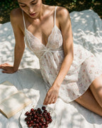 Darette White Flag Slip in Ivory - floral lace-trimmed chiffon slip, seated outdoors with cherries and a book